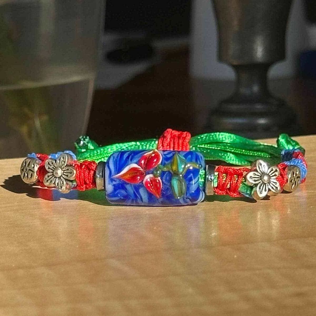 Cobalt Poppy | Lampwork Glass Flower Bracelet with Flower Charms on Red, Blue & Green Braided Cord