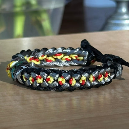 Cinder Marigold | Lampwork Glass Flower Bracelet on Black, Gray, Yellow & Red Braided Cord