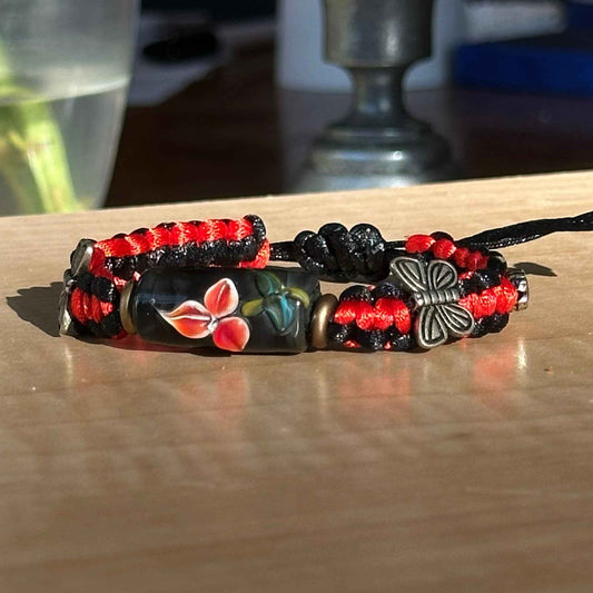 Ember Wing | Lampwork Glass Flower Bracelet with Butterfly Charm on Red & Black Braided Cord