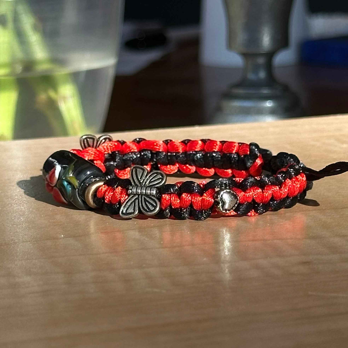 Ember Wing | Lampwork Glass Flower Bracelet with Butterfly Charm on Red & Black Braided Cord