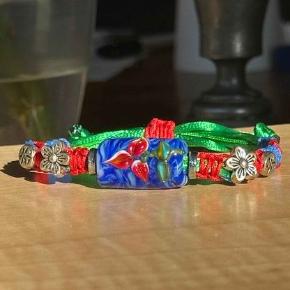 Cobalt Poppy | Lampwork Glass Flower Bracelet with Flower Charms on Red, Blue & Green Braided Cord